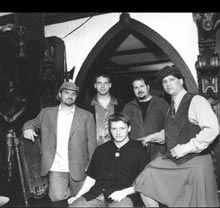 Band members posed in a castle.